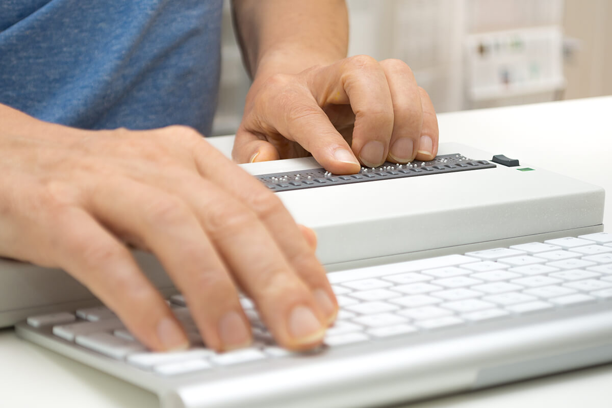 A visually impaired person using a braille display.