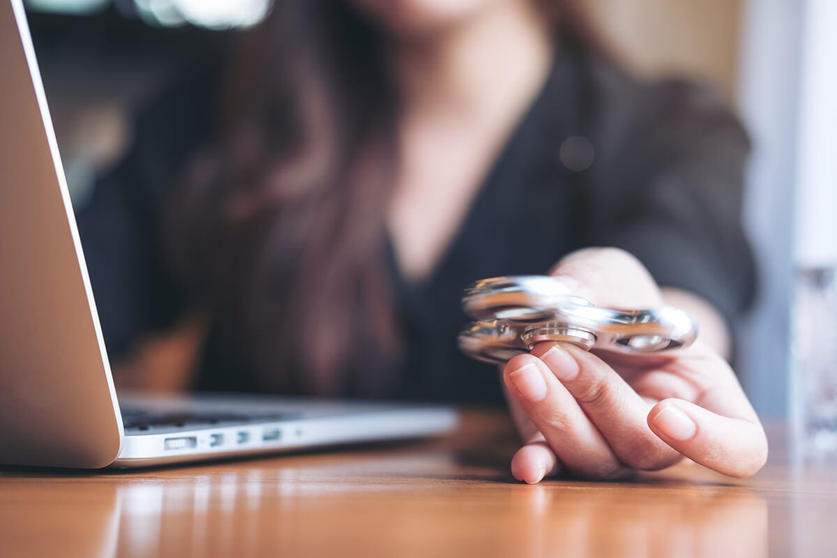 Woman playing with a fidget spinner.